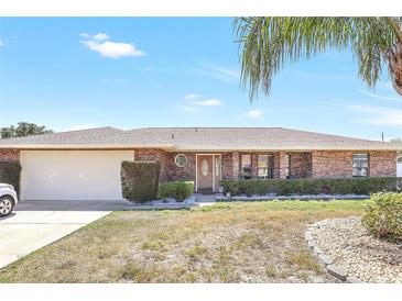Charming brick home with a two-car garage and well-maintained landscaping at 2102 E Atmore Cir, Deltona, FL 32725