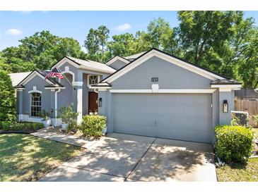 Charming home with a two-car garage and well-maintained landscaping at 2515 Wekiva Walk Way, Apopka, FL 32703
