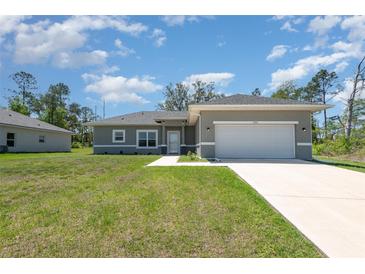 Charming single-story home with a two-car garage and a well-manicured lawn, perfect for suburban living at 2808 Sw 139Th St, Ocala, FL 34473