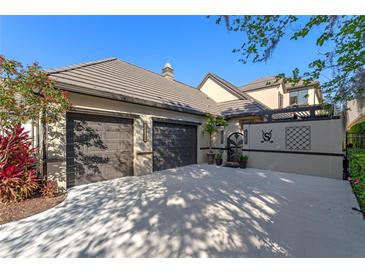 Inviting home exterior with two-car garage, driveway, and lush landscaping, perfect for curb appeal at 9624 Bryanston Dr, Orlando, FL 32827