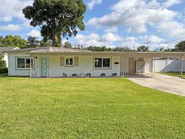 Charming single story home featuring a well-manicured lawn and a covered two car carport with extra storage at 605 Oranole Rd, Maitland, FL 32751