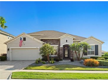 Charming one-story home featuring stone accents, manicured landscaping, and a well-maintained lawn at 970 Timberview Rd, Clermont, FL 34715