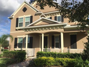 Charming two-story home features a cozy front porch, well-maintained landscaping, and classic architectural details at 14841 Porter Rd, Winter Garden, FL 34787