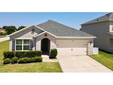 Charming single-story home with a well-manicured lawn and a two-car garage, offering classic suburban appeal at 3702 Maidencain St, Clermont, FL 34714