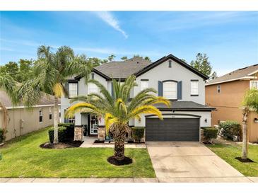 Charming two-story home with landscaped yard and a two-car garage at 460 Crownclover Ave, Orlando, FL 32828