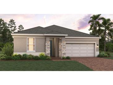 Charming single-story home featuring a two-car garage and well-manicured lawn at 7138 Rolling Leaf Rd, Groveland, FL 34736