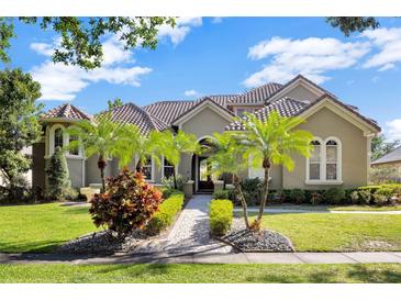 Beautiful single-Gathering home with well manicured landscaping, brick walkway, and tile roof at 9018 Southern Breeze Dr, Orlando, FL 32836