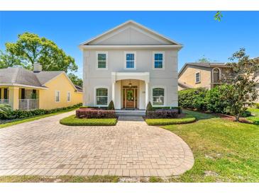 Charming two-story home with landscaped front yard and inviting brick paver driveway at 1341 Lyndale Blvd, Winter Park, FL 32789
