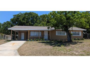 Charming single-story home with a well-maintained lawn and mature tree in the front yard at 2013 Sarazen Ct, Orlando, FL 32808