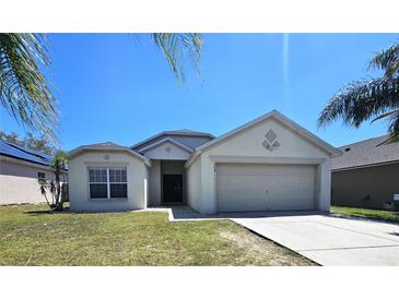 Charming single Gathering home featuring an attached two car garage and a well maintained lawn at 224 Lake Charles Dr, Davenport, FL 33837