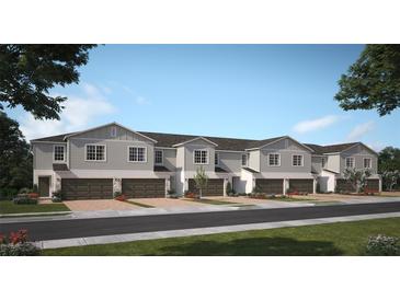 Charming new two-story townhomes featuring attached garages and beautifully landscaped front yards at 2580 Starry Pt, St Cloud, FL 34769