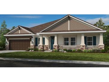 Charming single-story home featuring stone accents, a covered porch, and well-manicured lawn at 2963 Arranmore Dr, Ormond Beach, FL 32174