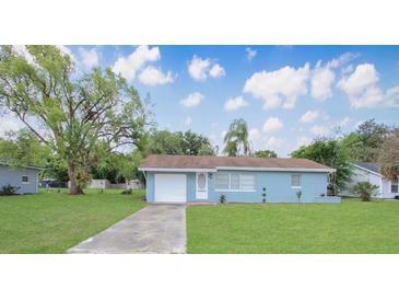 Charming single-story home with a well-manicured lawn and classic blue color scheme at 51 Park Ln, Debary, FL 32713