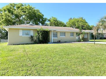 Charming single-story home boasts a lush green lawn and mature trees at 760 Eastridge Dr, Orange City, FL 32763