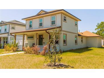 Charming two-story home with a welcoming front porch and well-maintained lawn at 900 S Maple Ave, Sanford, FL 32771