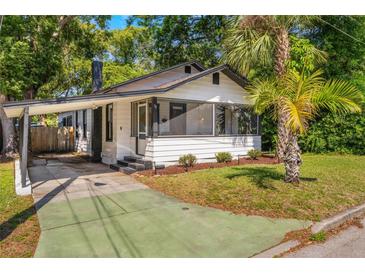 Charming bungalow featuring a carport, screened porch, and attractive landscaping at 12 N Forest Ave, Orlando, FL 32803