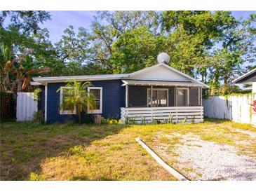 Charming single-story home with navy blue siding, white trim, and a cozy screened-in front porch at 1506 37Th St, Orlando, FL 32839
