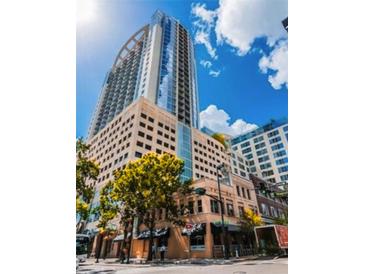 Contemporary high-rise building with a mix of glass and concrete facade in a bustling downtown setting at 155 S Court Ave # 1615, Orlando, FL 32801