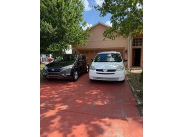 Charming single-Gathering home featuring a spacious garage and neatly maintained lawn at 220 Abbotsbury Dr, Kissimmee, FL 34758