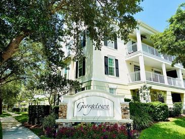 Beautiful exterior of a building with a Georgetown sign in front of the building surrounded by flowers at 315 Grand Magnolia Ave # 112, Celebration, FL 34747