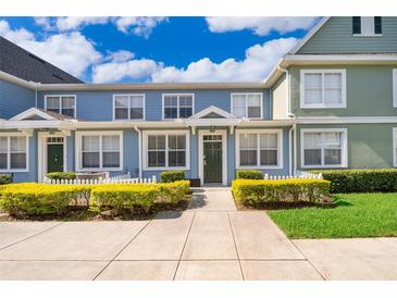 Charming townhome with a well-manicured front yard, complete with lush greenery and a welcoming entrance at 4011 Venetian Bay Dr # 103, Kissimmee, FL 34741