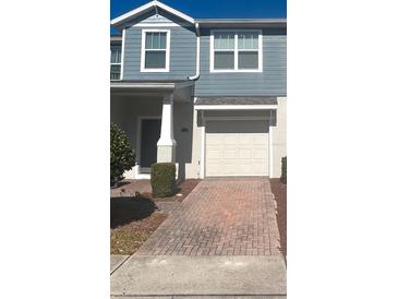Charming two-story home featuring a one-car garage and nicely manicured front yard at 4126 Hedge Maple Pl, Winter Springs, FL 32708
