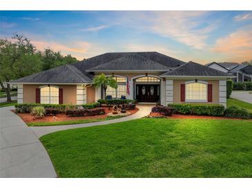 Stunning single-story home showcasing lush landscaping, mature trees, and classic architectural details at 421 Thomez Ct, Lake Mary, FL 32746