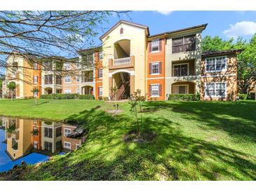Beautiful building with well maintained landscaping, small pond, and colorful paint at 725 Crest Pines Dr # 422, Orlando, FL 32828