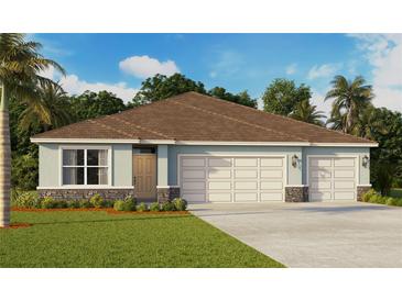 Charming single-story home with a three-car garage, well-manicured lawn, and beautiful landscaping at 1032 Morfontaine St, Daytona Beach, FL 32124