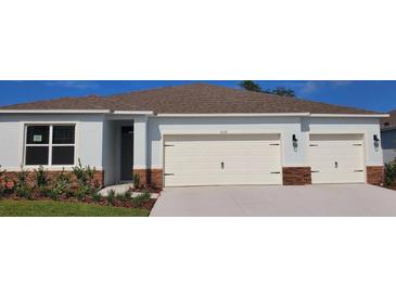 Charming single-story home featuring a three-car garage and well-maintained landscaping at 1032 Morfontaine St, Daytona Beach, FL 32124