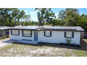 Charming single-story home featuring solar panels, a well-maintained lawn, and a freshly painted exterior at 1313 Pine Ridge Dr, Daytona Beach, FL 32117