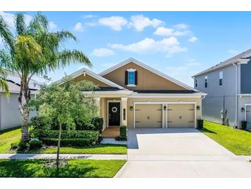 Charming single-Gathering home features a well-manicured lawn and an attached two-car garage at 15186 Book Club Rd, Winter Garden, FL 34787