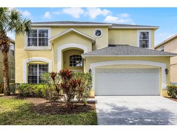 Charming two-story home with a well-manicured lawn and a spacious two-car garage at 2712 Lido Key Dr, Kissimmee, FL 34747