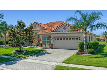 Lovely single-story home showing a well-manicured lawn and a decorative palm tree in the yard at 2721 Swoop Cir, Kissimmee, FL 34741