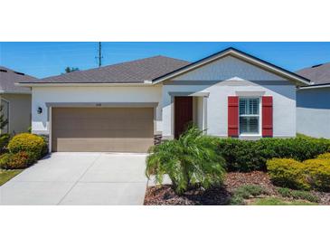 Inviting single-story home with a well-maintained lawn and neutral color palette at 308 Buchannan Dr, Davenport, FL 33837