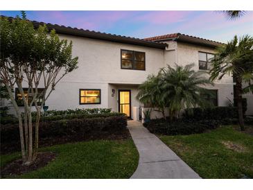 Charming two-story condo featuring well-maintained landscaping, mature trees, and a welcoming entrance at 640 Killarney Bay Ct # 4, Winter Park, FL 32789