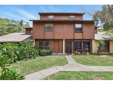 Two-story townhome featuring a well-maintained lawn and a symmetrical walkway leading to the front doors at 1005 Love Ln # 25, Apopka, FL 32703