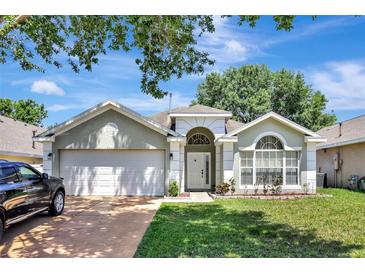 Charming single-Gathering home showcasing a well-maintained lawn and a two-car garage at 2848 Wilshire Rd, Clermont, FL 34714