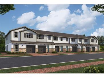 Charming townhomes feature attached garages, neutral colors, brick accents, and inviting entryways at 4291 Campsite Loop, Orlando, FL 32824