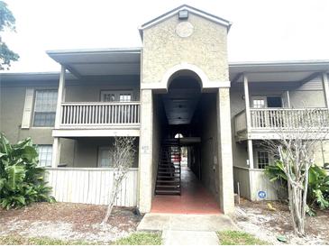 Inviting condo complex with central walkway, balconies, and mature landscaping at 455 Wymore Rd # 203, Altamonte Springs, FL 32714