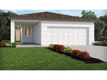 New construction home with an attached garage, a well-manicured lawn and colorful front yard landscaping at 4981 Kaia Ave, Winter Haven, FL 33884