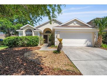 Charming single-Gathering home with well-maintained lawn, two-car garage, and classic architectural details at 5537 Misty Woods Dr, Oviedo, FL 32765