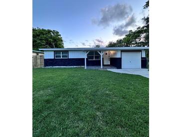 Charming single-story home featuring a well-manicured front lawn and welcoming entrance at 637 Ash Ave, Daytona Beach, FL 32117