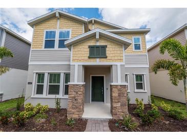 Inviting two-story home with stone accents, landscaped yard, and charming curb appeal at 6442 Pine Warbler Way, St Cloud, FL 34771