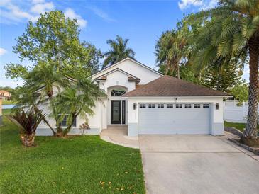 Charming single-story home with a well-manicured lawn, mature trees, and a two-car garage at 655 Eagle Pointe South, Kissimmee, FL 34746