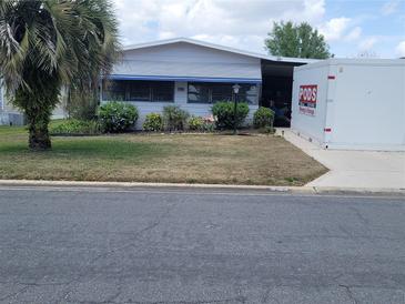 Charming single-story home featuring a well-maintained lawn, mature landscaping, and a bright exterior at 741 Truman Ave, Lady Lake, FL 32159