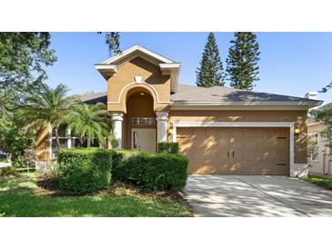 Charming single-Gathering home with a well-manicured lawn, mature trees, and an inviting front entrance at 1151 Chessington Cir, Lake Mary, FL 32746