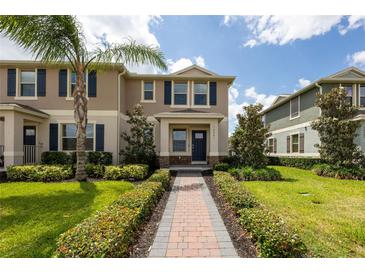 Inviting two-story home with a brick walkway, lush landscaping, and a pleasant facade at 16261 Admirals Cove Ln, Winter Garden, FL 34787