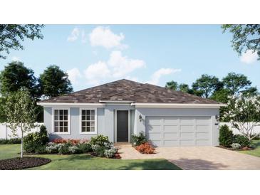 Charming single-story home with a two-car garage, light blue exterior, and beautifully landscaped front yard at 1822 Columbus Path, St Cloud, FL 34771