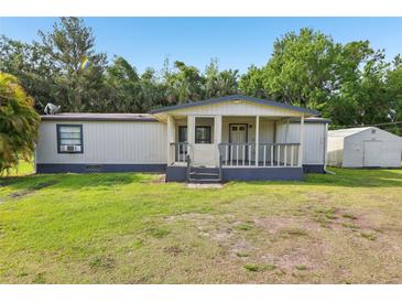 Charming single-story home featuring a covered front porch and a large yard at 1981 N County Road 426, Oviedo, FL 32765